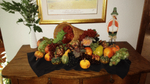 Festive Fall Cornucopia of fruit on an oak dresser.