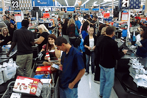 Rows of people standing in checkout lines at Walmart on Black Friday.