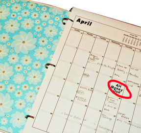 A paper date book with a date circled in red.