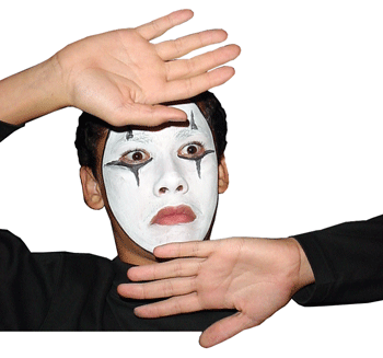 A boy with his face painted white, dressed up as a mime for halloween.