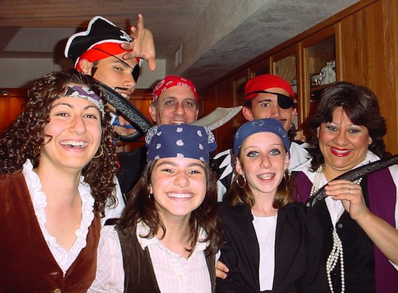 Seven people dressed up in pirate costumes.