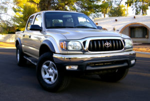 A Gold Toyota Tacoma parked in a cul de sac. Our daughter decided to buy used things to save money.
