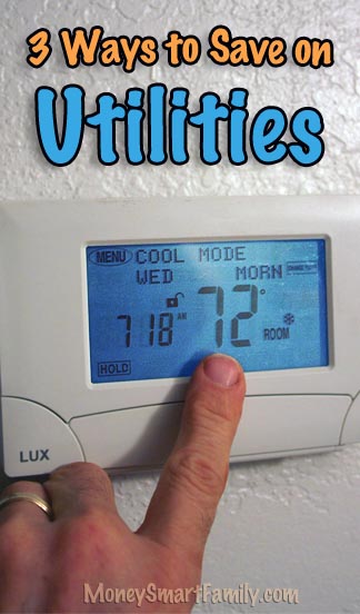 Programmable Lux thermostat with a finger pointing to it to adjust it.