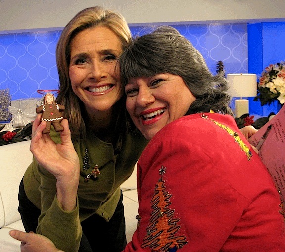 Meredith Viera with Annette Economides holding a brown gingerbread ornament.