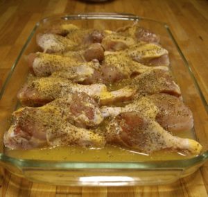 Chicken legs marinating in a lemon, olive oil and garlic marinade.