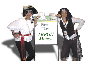 Two women dressed in Pirate costumes bought at thrift stores.
