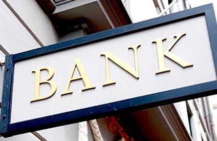 Best Inexpensive Places to Cash Personal Checks Without A Bank Account 4 A grey bank sign with golden letters. Some banks will cash peronal checks for a small fee.