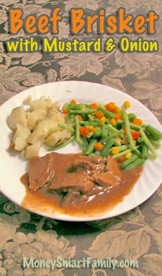 Chunk Beef Main Dish Recipes - Recipe Round-Up 4 Plate of beef brisket with mustard and onion gravy with mixed vegetables and baked potato on a white plate.