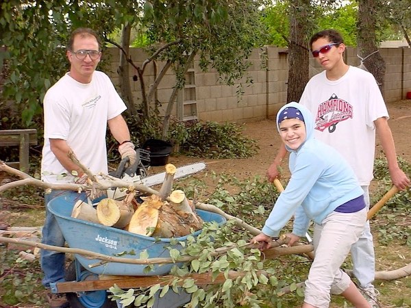 Family Teamwork: How to Accomplish More, Faster, Working Together 5 Tree trimming using a chain saw, hand saws and rakes.