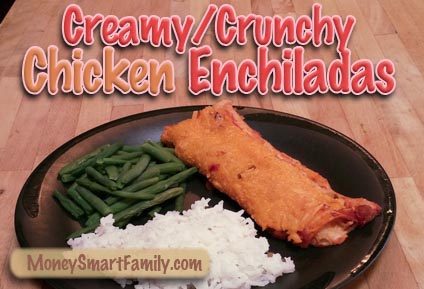 Chicken-Enchalada-Horiz Black plate with white rice, green beans and a chicken enchilada covered with cheese.