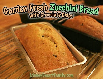 12 Easy Bread Recipes - Round-Up Page 4 Several loaves of fresh zucchini bread with chocolate chips sitting in silver and black metal loaf pans.