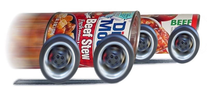 Two cans of dintey moore beef stew with mag wheels on them racing very fast.