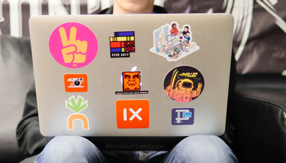 A mac laptop with free stickers on it.