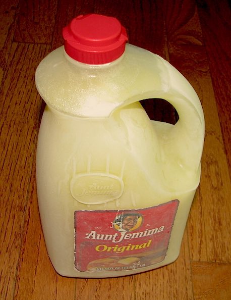 9 Easy Tips to Freeze Milk and How to Thaw it Safely 2 A half gallon of frozen milk in an Aunt Jemima syrup container