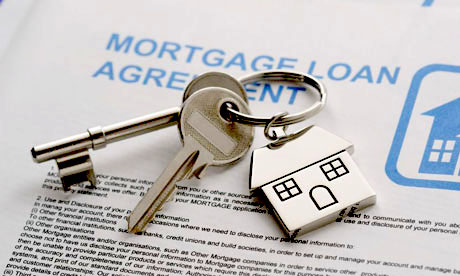 Mortgage document with two keys on a keyring.