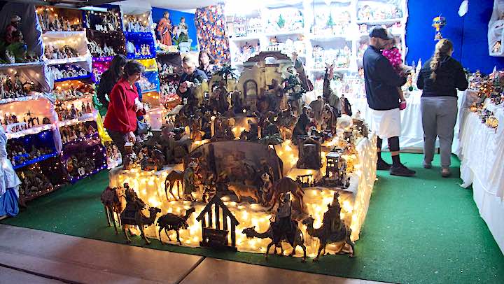 Fun Family Christmas Traditions: 9 Exciting and Inexpensive Holiday Activities 4 Many nativity scenes on display in a garage.