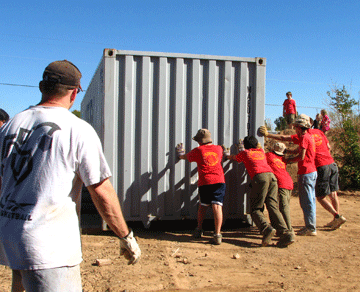 Family Teamwork: How to Accomplish More, Faster, Working Together 7 A team of kids moving a second storage container.