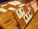 Rummy cubes number game on an oak table.