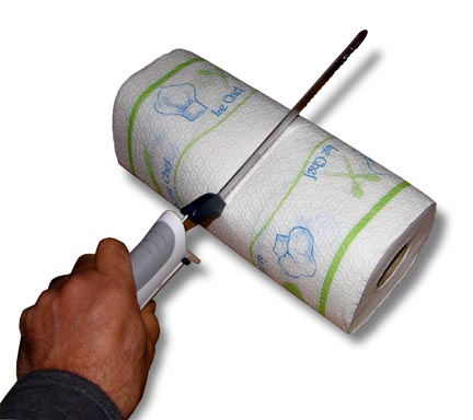 Cutting a paper towel roll in half with an electric knife.