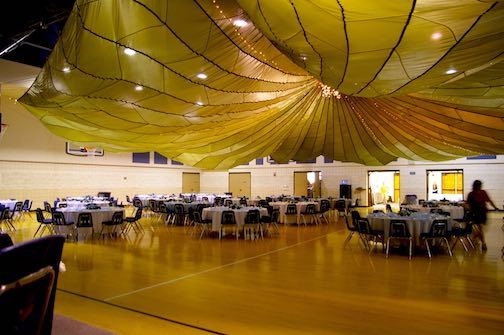 Family Teamwork: How to Accomplish More, Faster, Working Together 6 A large cargo parachute hung over a banquet hall.