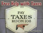 A block wall with a sign that says "Pay Taxes Room 108."