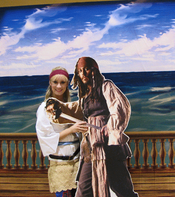 Special Occasion Gifts, Tips & Ideas 3 A girl standing with a Johnny Depp poster from Pirates of the Carribean.