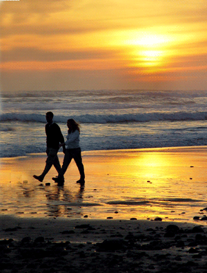Is Buying a Timeshare Really Worth It? Are They a Scam or a Good Investment? 2 A couple walking on the beach at a timeshare at sunset.