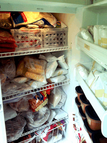 15 Ways to Wreck Your Food Budget 7 Upright freezer crammed with frozen food - very messy.