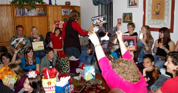 Fun Family Tradition Examples: For the Holidays and The Whole Year 2 White Elephant Gift Exchange presents being held up in the air.