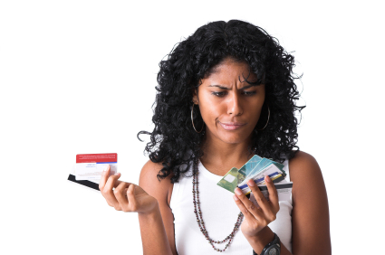 A woman with two hands full of credit cards trying to decide which one to use.