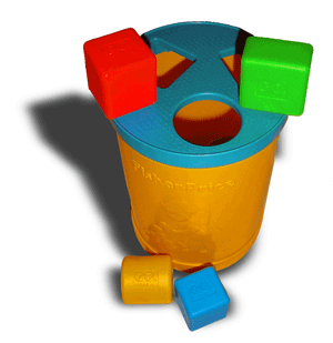 A child's toy: Yellow plastic cylinder with a blue lid and colored blocks.
