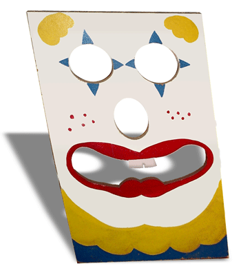 Bean bag toss with a clown face painted on it.