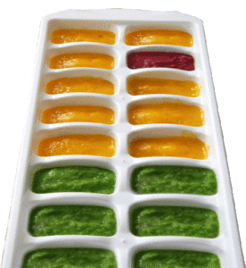 Green, Yellow and Red frozen baby food in a white ice cube tray.