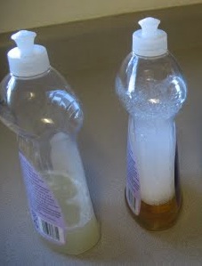 Two partial bottles of dishwashing soap.