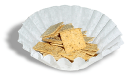 A coffee filter with wheat thins in it.